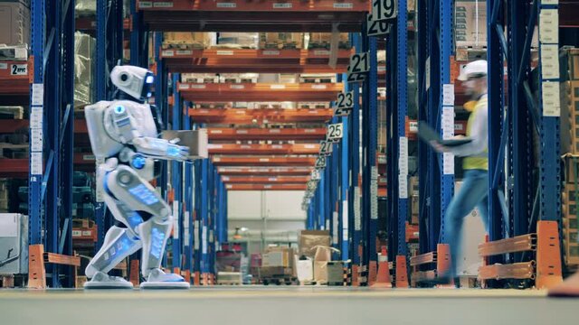 Warehouse hall with a cyborg and male workers crossing it