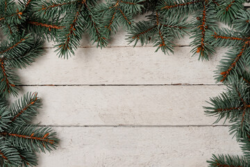 Christmas fir tree on a white wooden background, copy space