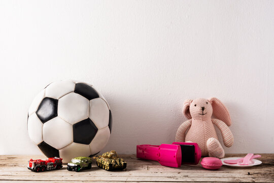 Gender Stereotype Toys On Wooden Table And White Background