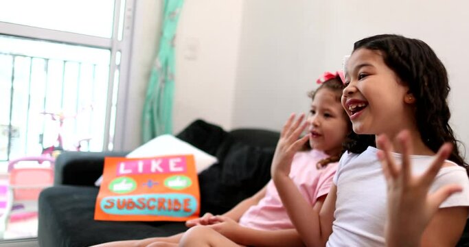Children talking to camera building social media presence, two little girls vlogging
