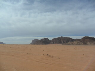 Hiking in the red desert sandcliffs and dunes of Wadi Rum in Jordan, Middle East