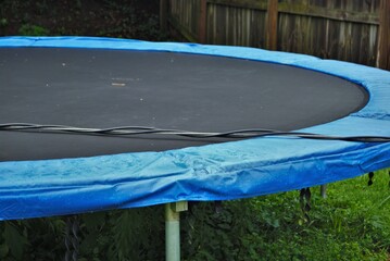 Dangerous live downed power line draped across trampoline