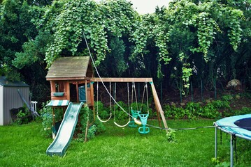 Dangerous live downed power line draped across trampoline and backyard playground
