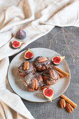 chocolate muffins with pecan and figs on gray background