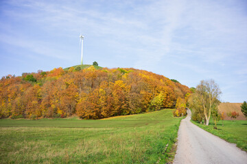 Wind turbine on an artificial hill built from the ruins and rubble from World War II