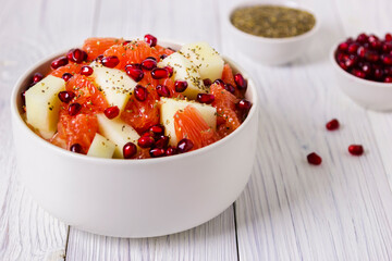 Fresh fruit salad in bowl on wooden table. Concept healthy food, diet, vegan