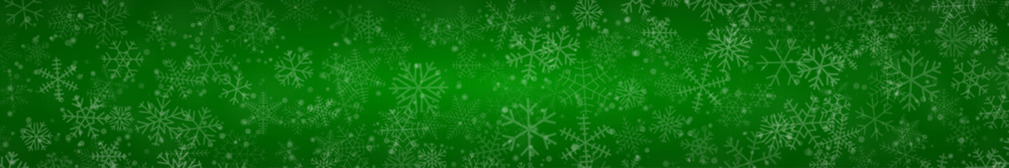 Christmas banner of snowflakes of different shapes, sizes and transparency on green background