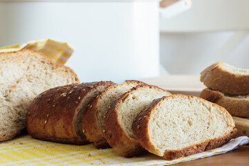 Close up homemade breads on yellow napkin wooden table in kitchen.Homemade food concept.