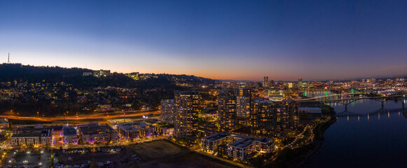 Naklejka premium South Portland Oregon on the Waterfront looking towards Downtown with Drone at Sunset