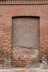 Immured window hole on red brick weathered textured wall - old vintage grungy texture - rough background