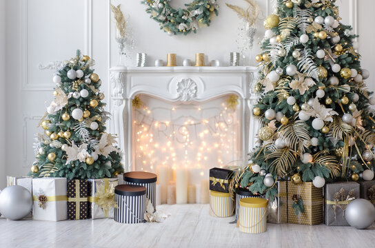 New Year decorated interior - bright living room or hall with Christmas decoration - fir-tree, gift boxes, fireplace decorated with garlands - hoilday celebration photo
