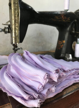 The Process Of Sewing Pieces Of Cloth That Will Be Used As A Mask. Plain Cloth As A Mask For A Tie-dyed Cloth That Has An Attractive Color. Hygienic Mask For Mouth Cover And Protection.