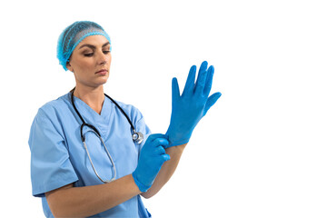 Female surgeon wearing protective gloves against white background
