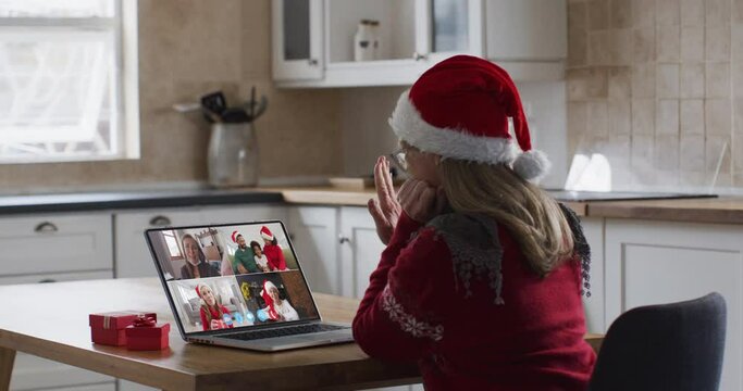 Caucasian woman spending time at home wearing santa hat