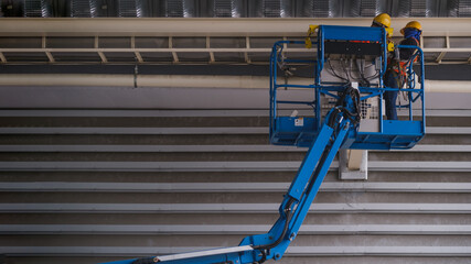 Install fire sprinkler system. In the industrial plant, pipe assembly, red fire pipe, fire protection contractors Using Scissor Lift High work