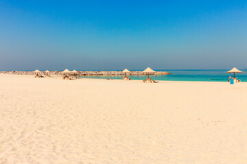 Fototapeta na wymiar Panoramic view on nice Al Mamzar beach in Dubai, UAE. United Arab Emirates famous tourist destination. Clear blue water Persian gulf, Indian Ocean
