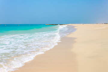 Fototapeta na wymiar Panoramic view on nice Jumeirah beach in Dubai, UAE. United Arab Emirates famous tourist destination. Clear blue water Persian gulf, Indian Ocean
