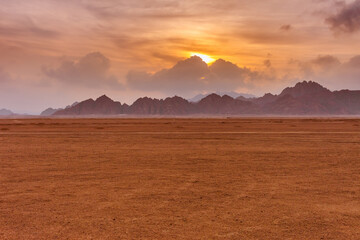 Orange beautiful sunset above mountains at Sinai Desert, Sharm el Sheikh, Sinai Peninsula, Egypt.