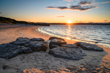 Budle Bay Sunset at high tide, where the mudflats at high tide are covered which are part of Lindisfarne Nature reserve on Northumberland's AONB coastline