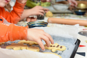 Kids are baking cookies in the kitchen the children are having fun adding ingredients to cook the food