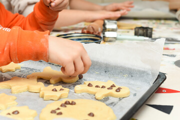 Kids are baking cookies in the kitchen the children are having fun adding ingredients to cook the food