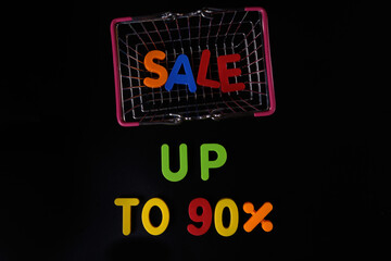 Black friday concept. Sale up to 90 per cent. Shopping basket at black