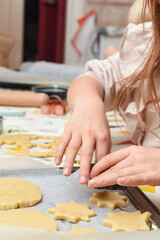 Kids are baking cookies in the kitchen the children are having fun adding ingredients to cook the food