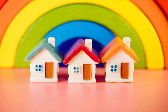 Miniature colorful house on rainblow background using as property and family concept