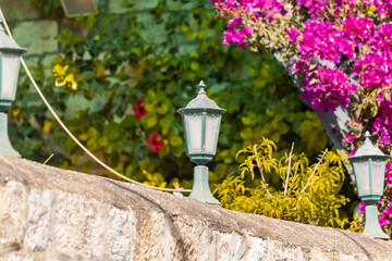 Fototapeta na wymiar Decorative lamps are on the fence in the territory of the Armenian quarter in the old city of Jerusalem, Israel