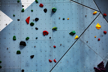 Street climbing wall close-up view with color grips
