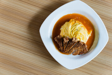 delicious fried pork chop in Japanese rice omelets also known as Omurice