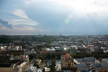 Panorama of the city of Lviv under thick clouds with a sunny glimpse.