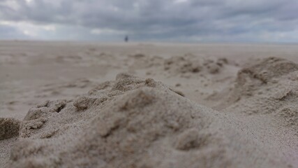 footprints in sand at the beach.