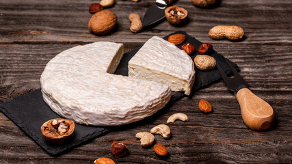 White cheese brie or camembert. The concept of oriental cuisine. National Italian French Gourmet appetizer cheese and nuts