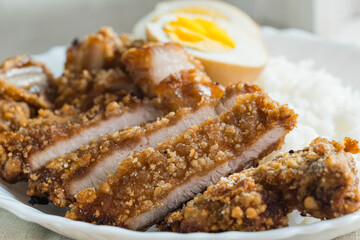 crispy fried pork that uses sweet potato flour with boiled egg and rice