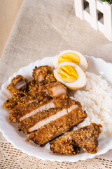 crispy fried pork that uses sweet potato flour with boiled egg and rice