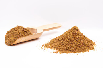  Cumin in a wooden spoon. Stack of cumin on a white background.