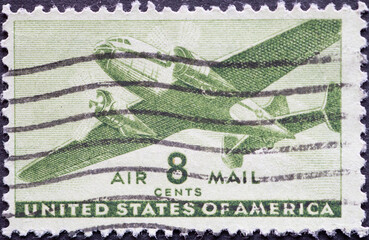 USA - Circa 1944: a postage stamp printed in the US showing a twin-motored transport airplane 8c...