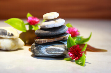 Sea stones with flowers on a marble background. Relax