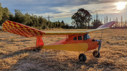 old radio control airplane at sunset