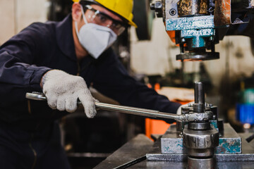 An Asian factory engineer works inside the factory