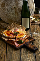 Baked Camembert cheese with toasted bread on wooden board