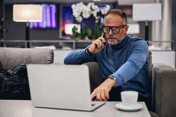 Concentrated businessman reading news on his computer