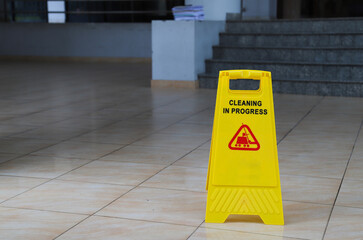 Closeup of caution sign on wet floor.