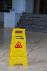 Closeup of caution sign on wet floor. Vertical view.