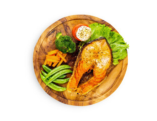 Salmon steak on wooden plate