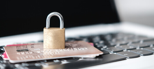 Computer internet credit card security concept with padlock. Credit card data security concept. Data encryption on credit card. The padlock is on Bank cards and laptop. Horizontal photo banner