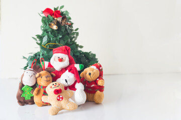 fun some dolls like reindeer bears cookies and christmas decorations next to santa claus have fun around a christmas tree in the prosperity of the new year in white background