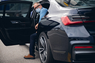 Man sitting in a car with an open door