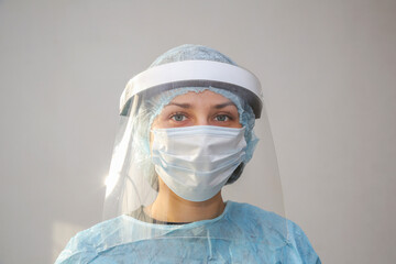 young woman doctor nurse in protective mask on white background